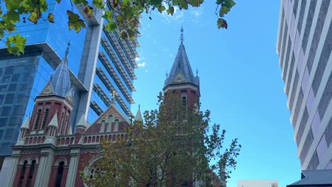 Spires-of-Trinity-Church,-wide-view,-Perth-CBD,-between-skyscrapers,-blue-sky