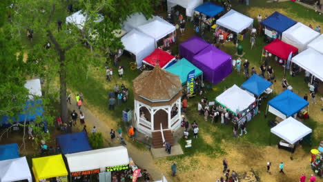 Colorful-Booths-With-People-Roaming-Around-At-50th-Dogwood-Festival-In-Siloam-Springs,-Arkansas