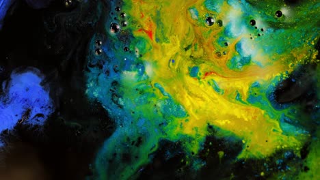 Vivid-abstract-paint-in-motion-with-swirling-colors-of-yellow,-blue,-green,-and-black,-close-up