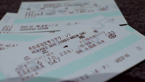 Macro-Shot-Of-Japan-Rail-Pass-Reservation-Tickets-Being-Stacked-On-Top-Of-Each-Other