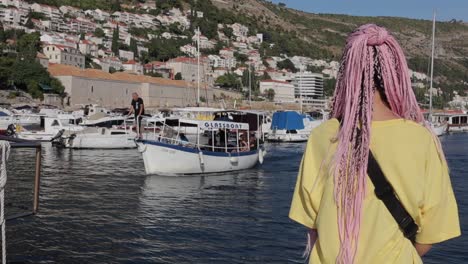 A-woman-watching-boats-in-Dubrovkin,-Croatia