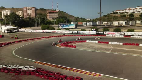 Aerial-follow-through-of-Go-karts-racing-on-a-track-at-the-national-championship-on-Isla-de-Margarita,-Venezuela