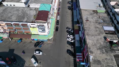 Lovely-aerial-view-flight-of-krabi-town-in-southern-thailand,-showing-a-mix-of-buildings,-a-river,-the-sea,-and-forested-hills-in-the-background