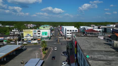 Smooth-aerial-view-flight-of-krabi-town-in-southern-thailand,-showing-a-mix-of-buildings,-a-river,-the-sea,-and-forested-hills-in-the-background