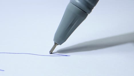 Drawing-line-with-blu-pen-closeup-view