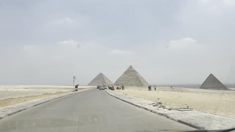 Tourist-moving-around-Egyptian-pyramids-riding-camel