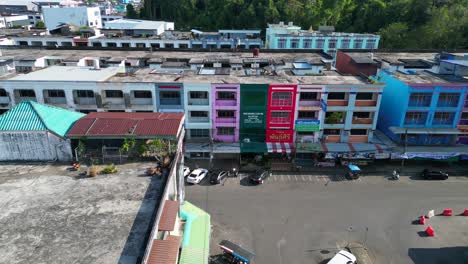 Fantastic-aerial-view-flight-of-krabi-town-in-southern-thailand,-showing-a-mix-of-buildings,-a-river,-the-sea,-and-forested-hills-in-the-background