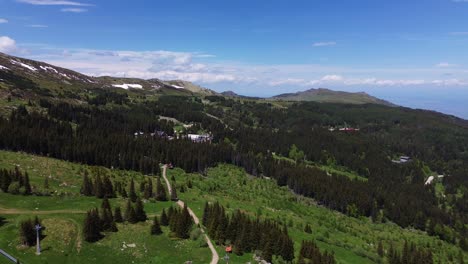 Hermosas-Imágenes-De-Drones-De-Primavera-En-Lo-Alto-De-Una-Montaña-Con-Nieve-Aún-En-Los-Picos-Más-Altos