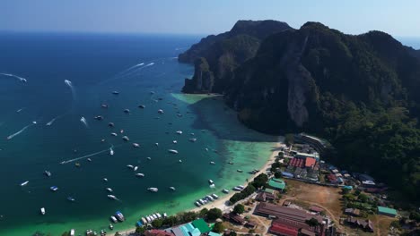 Turquoise-water-surrounding-tropical-island-with-lush-green-vegetation-in-thailand