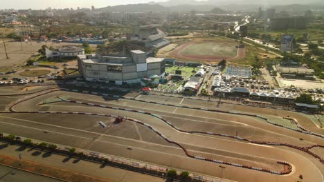 Aerial-pullback-of-go-karts-racing-on-a-track-at-the-national-championship-on-Isla-de-Margarita,-Venezuela