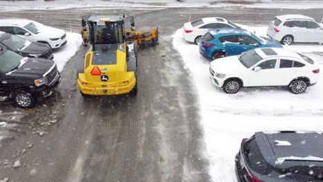 Tractor-Snow-Pusher-Clearing-Snow-On-Streets-During-Snowfall