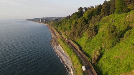 drone-shoot-of-Black-sea-Batumi-coast-beautiful-nature-railway-mountains-nature-side-of-Batumi-beach-sunset