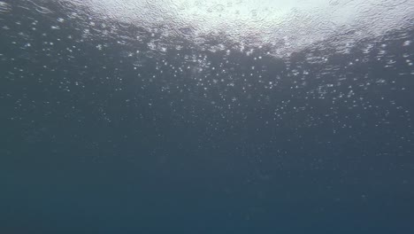 Las-Gotas-De-Lluvia-Crean-Patrones-Fascinantes-A-Medida-Que-Caen-Sobre-La-Superficie-Del-Océano,-Capturados-Desde-Debajo-Del-Agua.