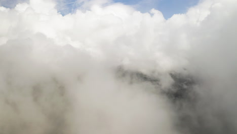 Soothing-serene-natural-background-of-clouds-over-forest,-aerial-drone-establishing