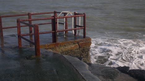 Rusty-platform-at-Portmarnock-Beach-for-winter-sea-swimming-in-Dublin,-Ireland