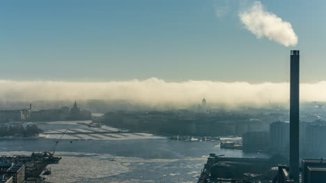 Time-lapse-of-sea-fog-covering-the-frozen-Kruununhaka-skyline,-winter-in-Helsinki