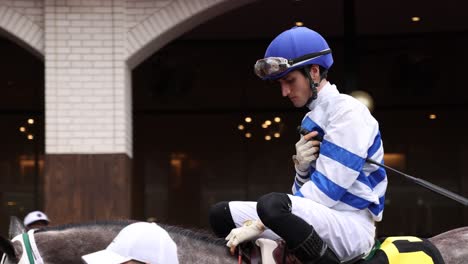 Footage-of-Lemon-Muffin,-a-Kentucky-Oaks-contender,-with-rider-in-the-paddock-before-the-race,-showcasing-pre-race-anticipation