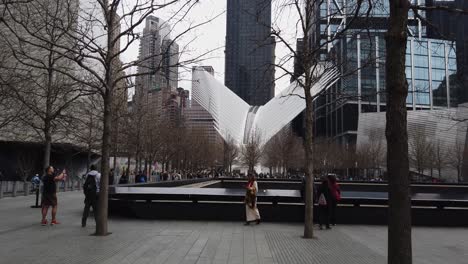 Shot-of-the-9-11-memorial-with-the-urban-transport-interchange-station-designed-by-architect-Santiago-Calatrava-in-lower-Manhattan-in-New-York-City