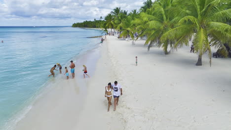 Retreating-drone-shot-showing-some-tourists-at-the-beachfront-of-a-popular-resort-in-Dominican-Republic-in-the-Caribbean-island