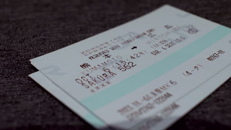 Close-Up-View-Of-Japan-Rail-Pass-Reserved-Tickets-Being-Stacked-On-Top-Of-Each-Other