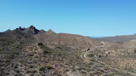 Aerial-view-of-desert-ecosystem,-dry-landscape-with-hills-and-mountains-in-Baja-California-sur,-Mexico