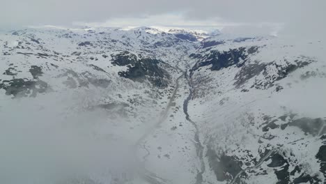 Eerie-snowy-mountains-covered-by-clouds