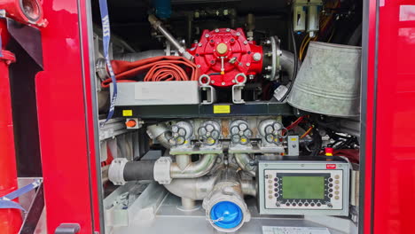 A-close-up-of-a-fire-truck's-intricate-pump-system-showcasing-detailed-mechanics-and-controls