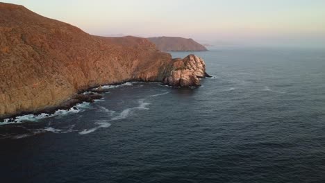 Golden-hour-at-Punta-Lobos,-beautiful-scenery-of-hills-and-rocky-shoreline-in-Baja-California-Sur,-Mexico