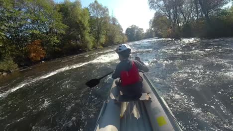 Point-of-view-shot-canoeing-down-rapids-in-a-forest,-Slovakia