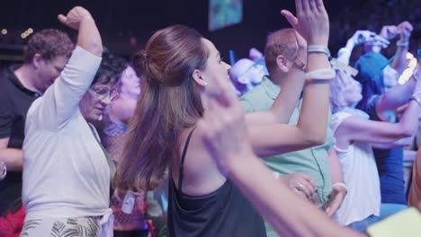 Closeup-of-a-young-brown-haired-woman-having-a-good-time-dancing,-slow-motion