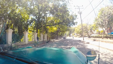 POV-From-Passenger-Seat-Of-Taxi-Driving-Through-Urban-Streets-Of-Havana-Cuba