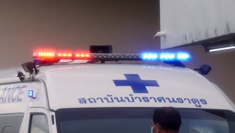 Ambulances-turn-on-emergency-lights-while-transporting-patients-infected-with-Corona-2019-during-the-global-Covid-19-epidemic-situation-in-Nonthaburi,-Thailand