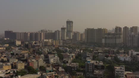 Aerial-Drone-Footage-Of-urban-City-buildings,-residential-houses-and-pollution-in-New-Delhi,-India-4k-UHD