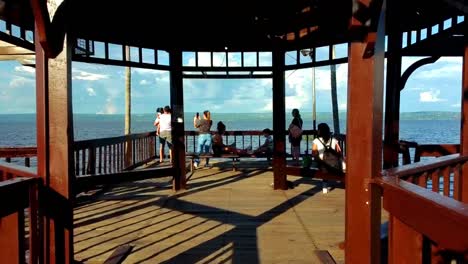 Family-standing-on-the-pier-of-the-lake-Ypacarai-in-the-city-of-Aregua