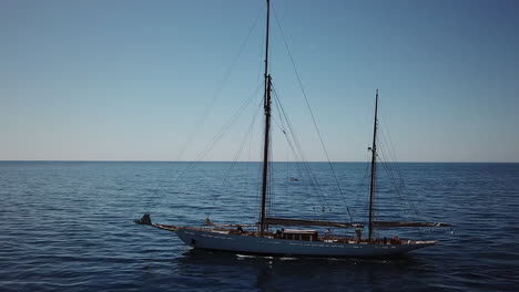 Tall-ship-with-two-masts-moves-through-open-ocean