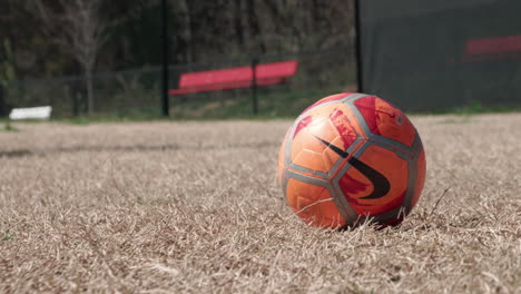 Kicking-a-Nike-soccer-ball-in-slow-motion,-Closeup