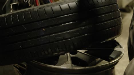 Close-up-of-hands-of-a-tire-repairman-removing-a-tire-from-its-rim