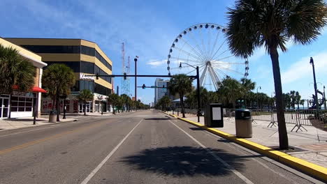 A-forward-driving-view-of-an-empty-street-in-Myrtle-Beach,-SC