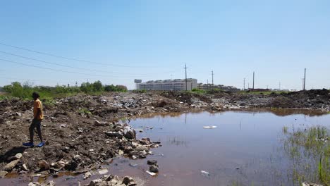 Child-in-the-middle-of-pile-of-garbage-on-Kibera,-is-the-largest-slum-in-Nairobi,-and-the-largest-urban-slum-in-Africa