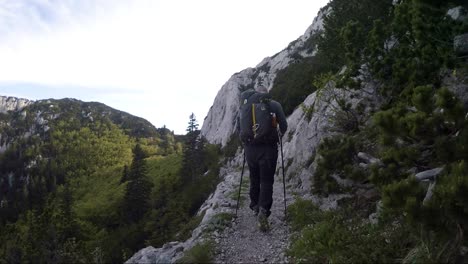 A-hiker-walking-alone-along-the-trail-in-the-mountains-on-a-sunny-day-in-Croatia