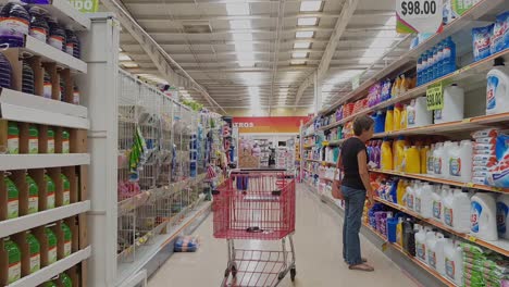 Walking-through-the-aisles-of-the-supermarket-and-people-deciding-what-to-buy