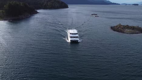 Aerial-reveal-shot-of-a-ferry-sailing-at-the-lake-of-Nahuel-Huapi-in-the-Argentinean-Patagonia