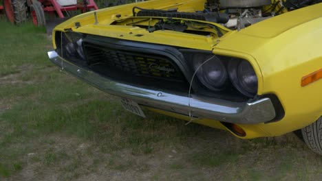 Reveal-shot-of-Dodge-Challenger-vintage-car-with-the-bonnet-opened-showing-the-motor