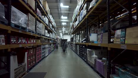 POV-View-Across-Floor-To-Ceiling-Stacked-Aisle-Shelves-In-Costco-Hayes-On-28-May-2022