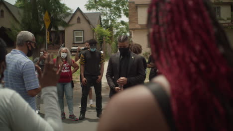 Praying-during-silent-protest-with-group-of-people-in-neighborhood-during-a-sunny-day