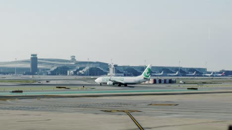 Transavia-airplane-slowly-moving-on-taxiway-towards-airport-terminal