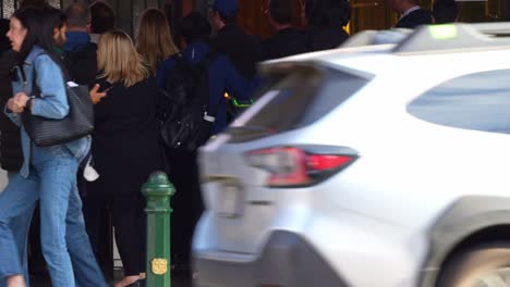 Daily-commuters-rushing-through-the-gate-at-Flinders-Street-Station-in-Melbourne-city-during-peak-hours,-paying-fares-by-tapping-Myki-card-on-the-payment-machines,-slow-motion-shot