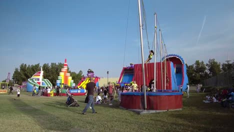 The-Colorful-Winter-Carnival-In-Abu-Dhabi,-UAE-On-A-Bright-Sunny-Day---Wide-Tilt-Up