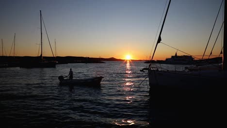 Boats-and-yachts-enter-and-exit-marina-at-sunset-in-Biograd-in-Croatia