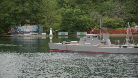 A-replica-battleship-at-Peasholm-Park,-Scarborough,-during-the-traditional-naval-battle-reenactment